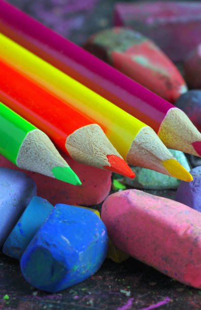 multicolored pastel crayons and colored pencils close up
