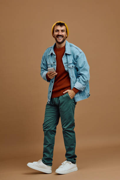 istock Portrait of casual man using cell phone and looking at camera. 2179342238