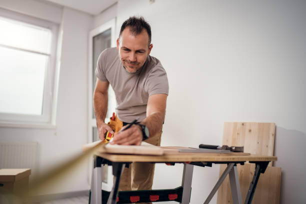 istock Professional carpenter at work measuring wooden planks 2179345458