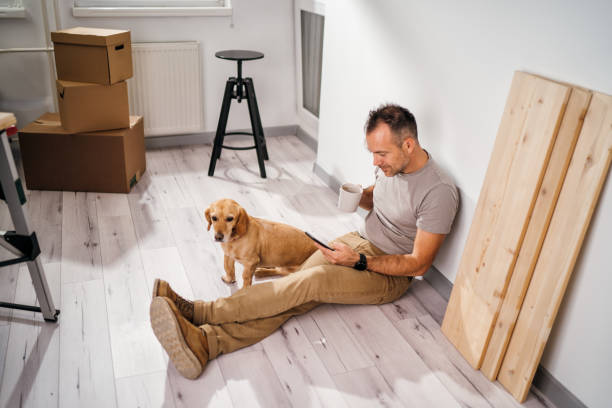 istock a man with his dog moves into a new empty apartment 2179353796