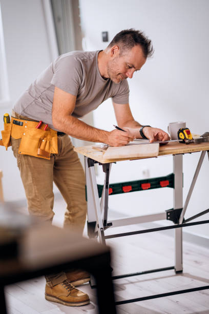 istock A handsome smiling carpenter measuring a wooden board 2179356814
