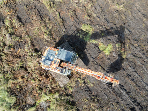 istock Drone view of a bulldozer flattening ground on a peat bog 2179366561
