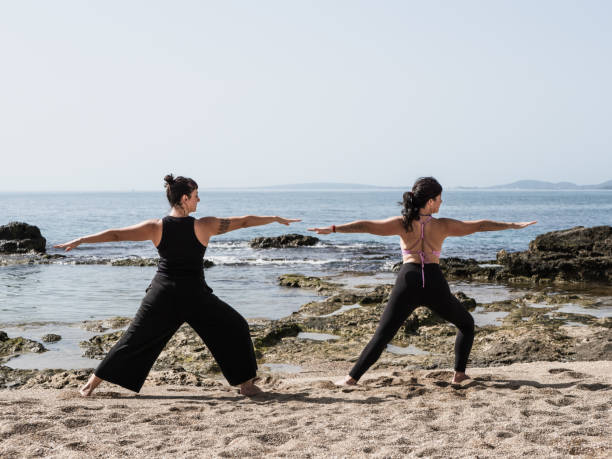istock Two women practicing yoga outdoors 2179383535