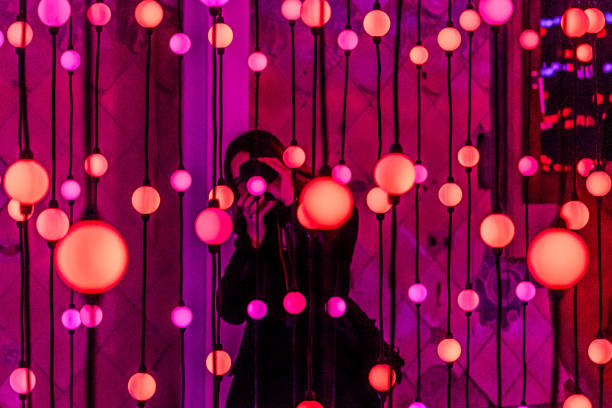 A visitor photographs a mesmerizing display of hanging lights at the Sant Pau modernist complex during the \