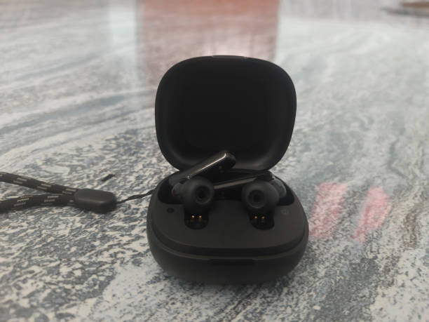 istock Holding a Black color TWS or Ear buds. Bluetooth Headset. 2179395450