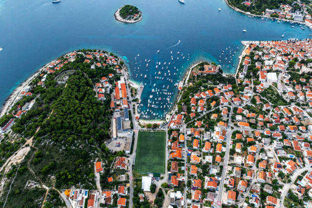 High angle view of Hvar town on the island of Hvar seen by the beautiful blue Adriatic sea and photographed with a drone during one sunny day.
