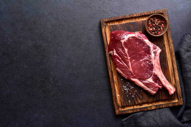istock Fresh raw tomahawk steak on a wooden cutting board . Top view with copy pace. 2179410047