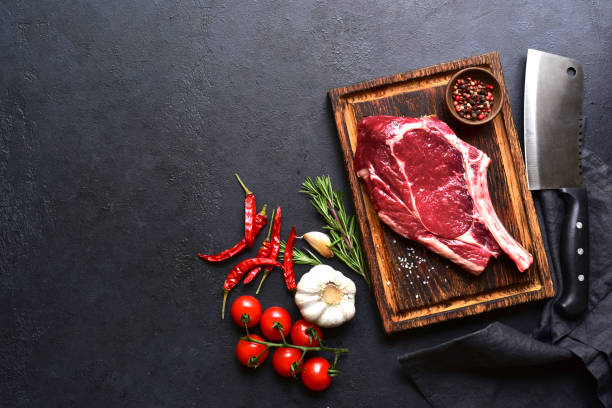 istock Fresh raw tomahawk steak on a wooden cutting board . Top view with copy pace. 2179410083