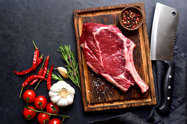 istock Fresh raw tomahawk steak on a wooden cutting board . Top view with copy pace. 2179410086