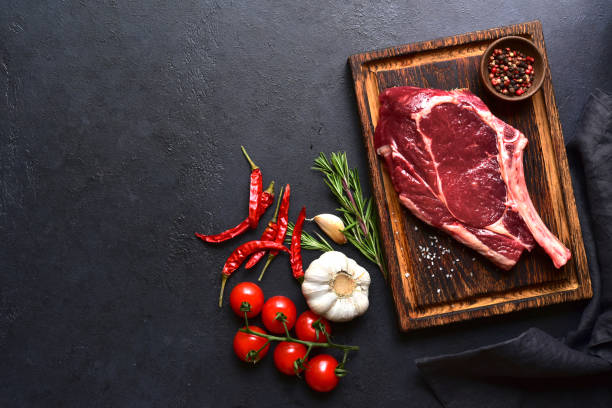 istock Fresh raw tomahawk steak on a wooden cutting board . Top view with copy pace. 2179410113