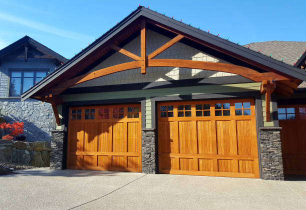Vernon, British Columbia, Canada- October 18,2024: Large residential attached Garage. Architectural feature above doors. Driveway in front. Partial home next door. Stone and wood materials used.