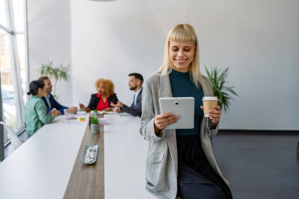istock Professional with tablet and coffee, casual smile 2179414781