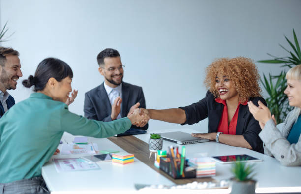 istock Diverse team celebrates successful business handshake 2179415603
