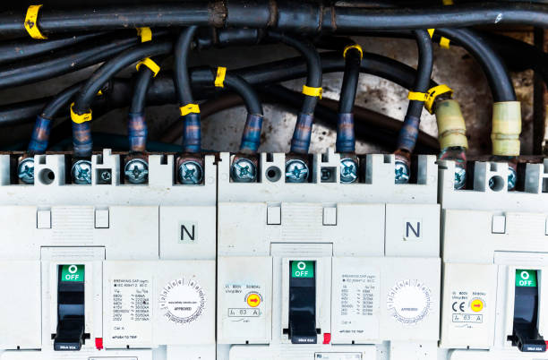 istock Electric cables connected to a distribution block with switches, close-up. 2179418524