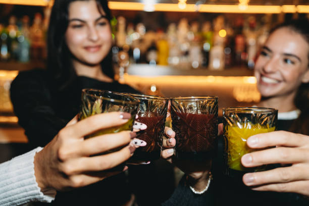 istock Friends toasting drinks at bar counter 2179420825