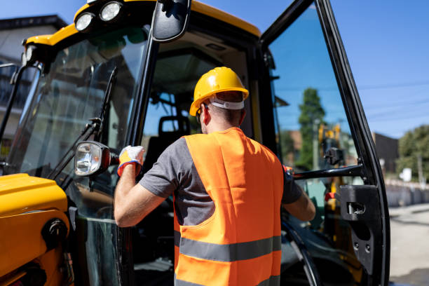 istock Construction worker getting ready to operate heavy machinery at a building site on a bright sunny day 2179421583
