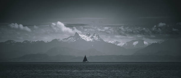 istock Sailboat with canadian mountains background black and white 2179423799