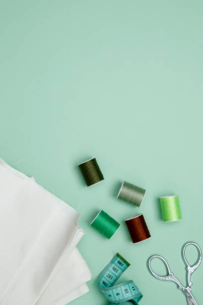 istock Composition with various threads and sewing accessories on green background. Top view, copy space 2179424726