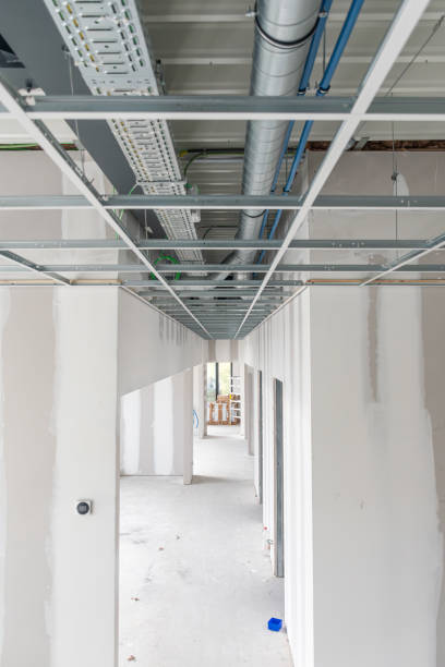 istock Bottom view of ceiling ventilation system, ceiling structure with electrical wiring and ventilation pipes made of silver insulating material, air conditioning and ventilation installation 2179429958