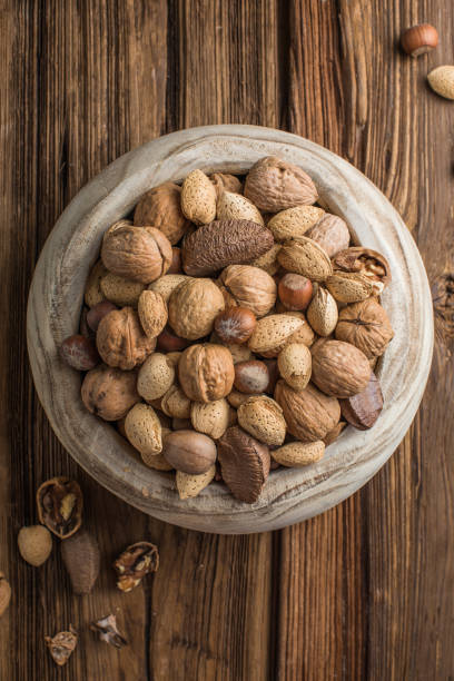 istock mixed nuts - hazelnuts walnuts almonds pine nuts brazil cashew pistachios peanuts 2179436328