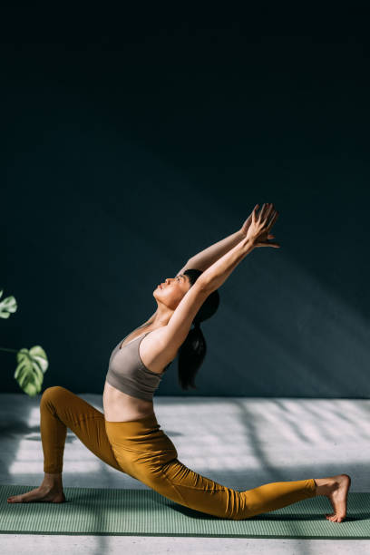 istock Serene Woman Practicing Yoga On a Sunny Day Indoors 2179438443