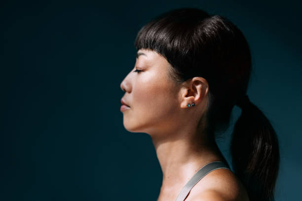 istock Serene Profile of Woman With Peaceful Expression in Dark Background 2179438453