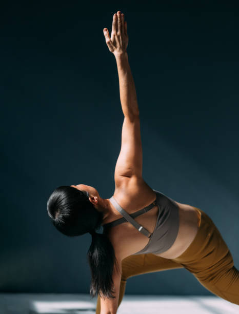 istock Serene Woman Practicing Yoga Under Soft Natural Light Indoors 2179438454
