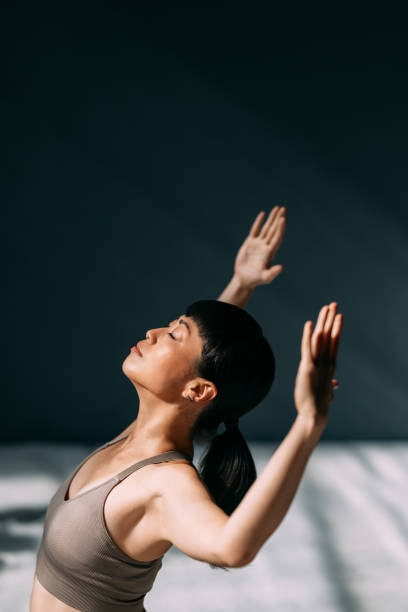 Woman Practicing Mindfulness with Yoga in Sunlit Room