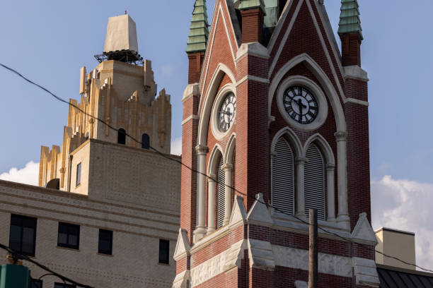 Monroe, Louisiana, USA - April 4, 2024: Afternoon sunlight shines on the historic buildings and church in the skyline of downtown Monroe.
