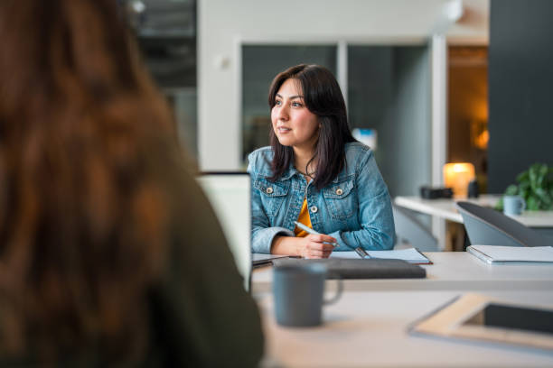 istock Engaged Hispanic Businesswoman in Strategy Session 2179470759