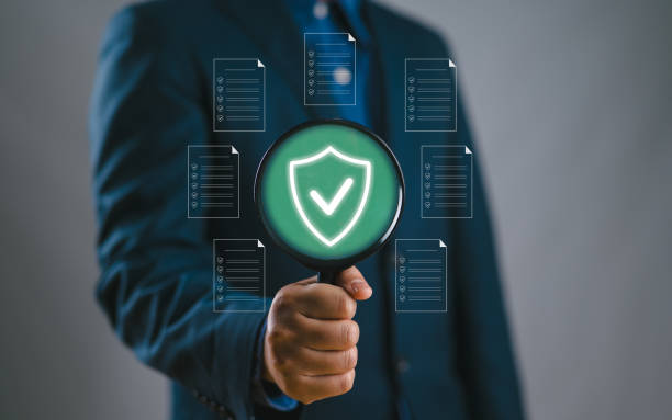 istock Businessman holding magnifying glass with standard quality control certification assurance guarantee for automation process. Quality management, Quality Assurance, Standardization, health insurance. 2179473176