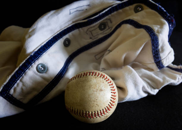 Baseball with dirt on it sitting atop pitchers mound close up