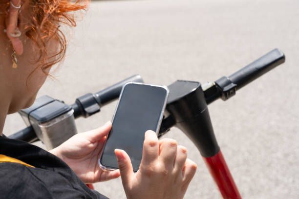 istock An unrecognizable woman renting an electrical scooter paying by smartphone 2179481319