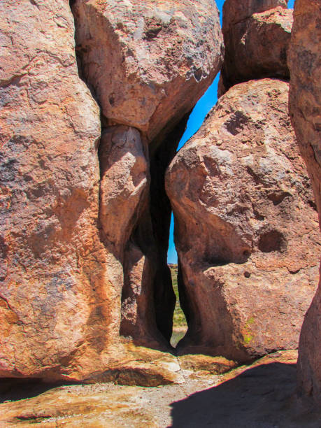 istock Red Rocks Stacked Standing Up Right Forming A Small Paasage 2179483331