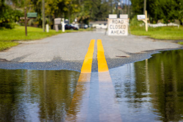 istock Water flooding onto road 2179492143