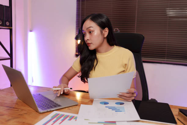 istock Asian woman sitting at work, busy with documents, stressed face, busy with work. 2179493978