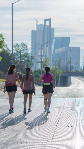 istock Three women walking outdoors towards cityscape on a sunny morning 2179494792