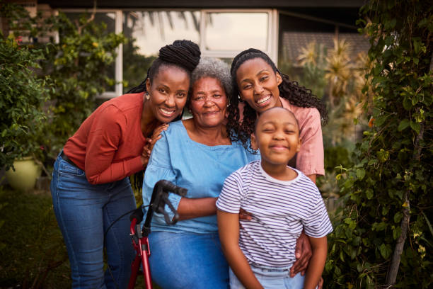 istock Front view of affectionate multi-generation family smiling at camera in garden 2179497379
