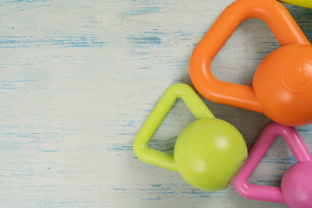istock close up  kettlebell on a blue wodden table background, flat lay sport concept 2179500328