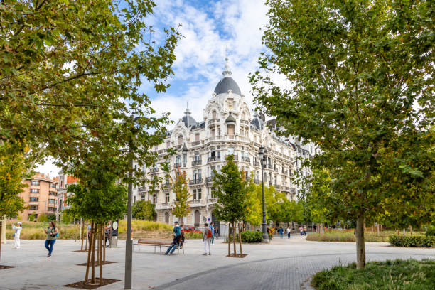 Madrid, Spain - october 2, 2024: Details of the different buildings surrounding the Square Spain in Madrid with people walking through its streets in Madrid, Spain