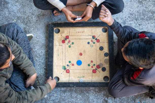 istock Three Children Playing Carrom Board Game Outdoors 2179510914
