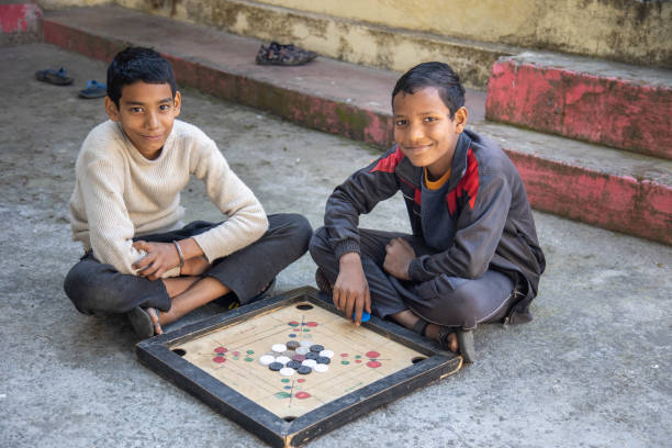 istock Two Children Playing Carrom Board Game Outdoors 2179510955