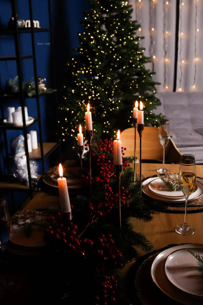 istock Christmas dinner table in the background a Christmas tree with garlands. festive mood 2179513407