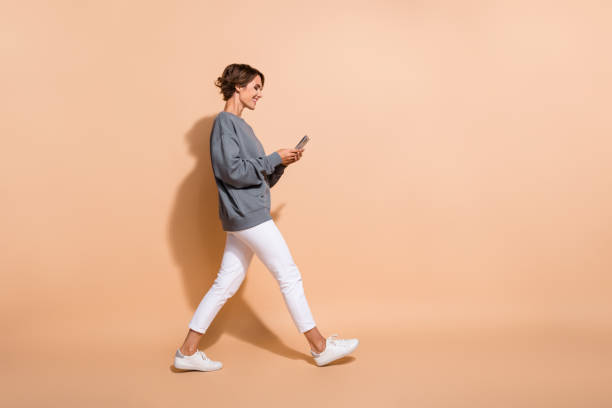 istock Full size photo of smart woman dressed grey pullover read notification on smartphone go empty space isolated on pastel color background 2179525908
