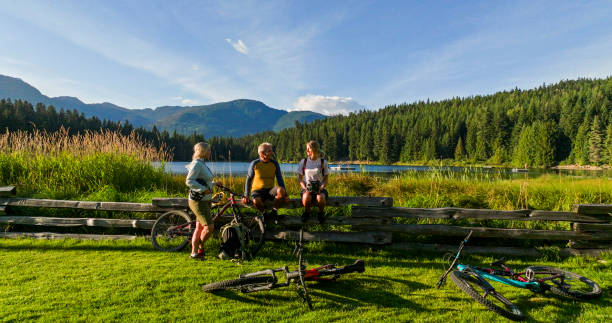 istock Family with mountain bikes pause by lakeshore 2179530950