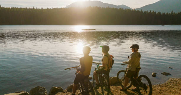 istock Family with mountain bikes pause on lakeshore 2179531003