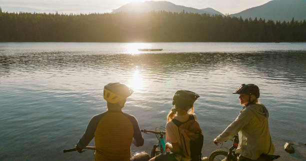istock Family with mountain bikes pause on lakeshore 2179531540