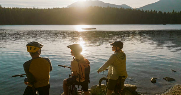 istock Family with mountain bikes pause on lakeshore 2179531577