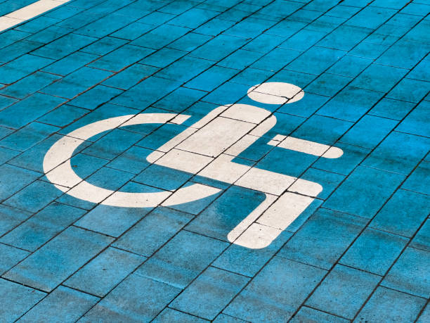 istock A designated parking spot reserved for disabled individuals features a bright blue paving and a clear accessibility symbol painted in white. This ensures easy identification and access 2179532310