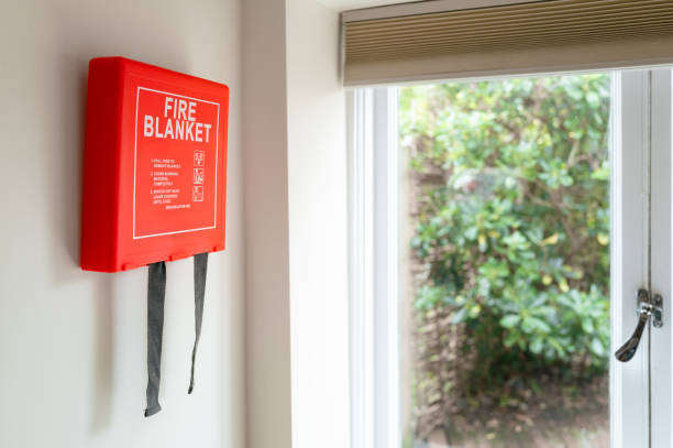 Newly installed generic Fire Blanket stowage kit seen by a rear window in a typical kitchen environment. stock photo